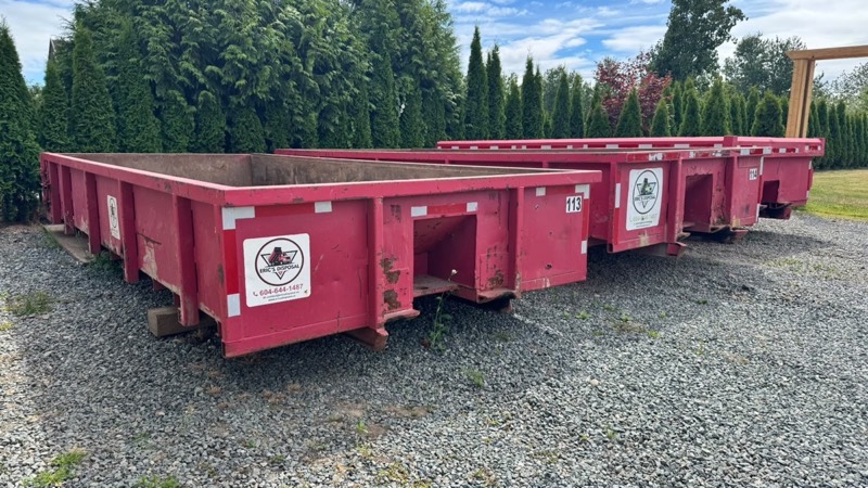Eric's Disposal roll off bins staged and ready, showing the clean empty interiors