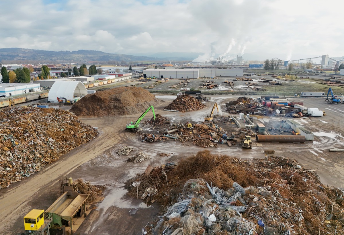 Sorted wood and metal piles at a recycling yard